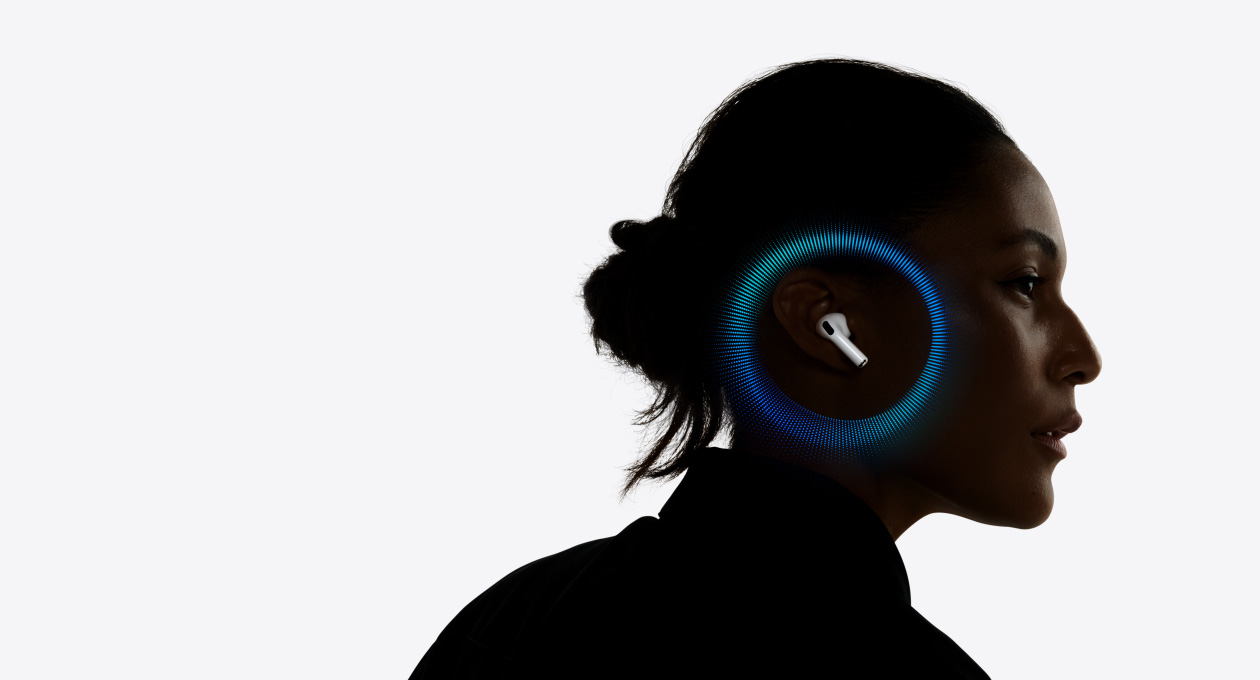 A person wearing AirPods Pro 3, pulsating waves around their ear